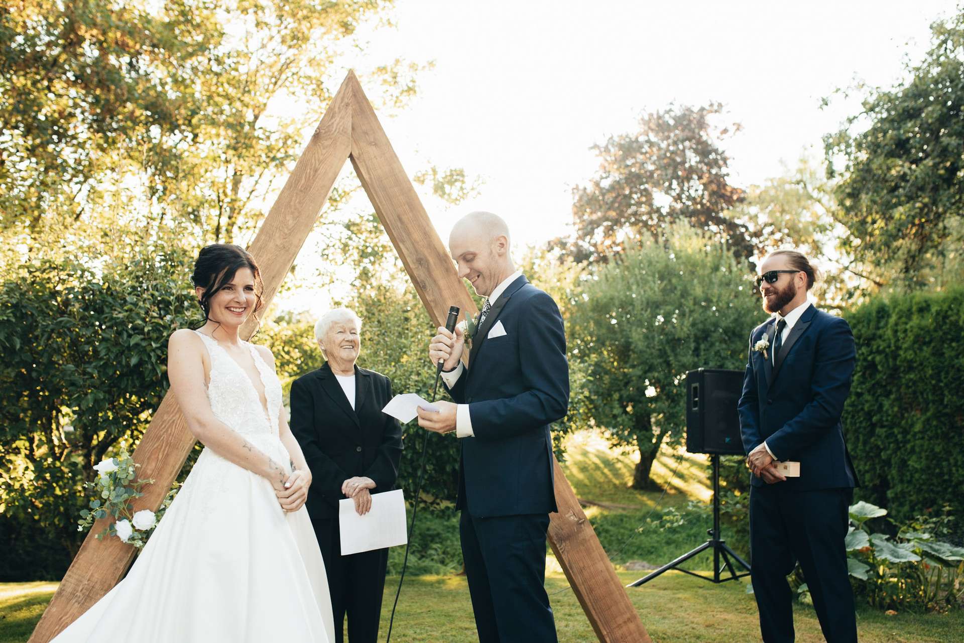 Beautiful bride and groom in a lush yard surrounded by greenery. Captured by wedding photographer in Vancouver